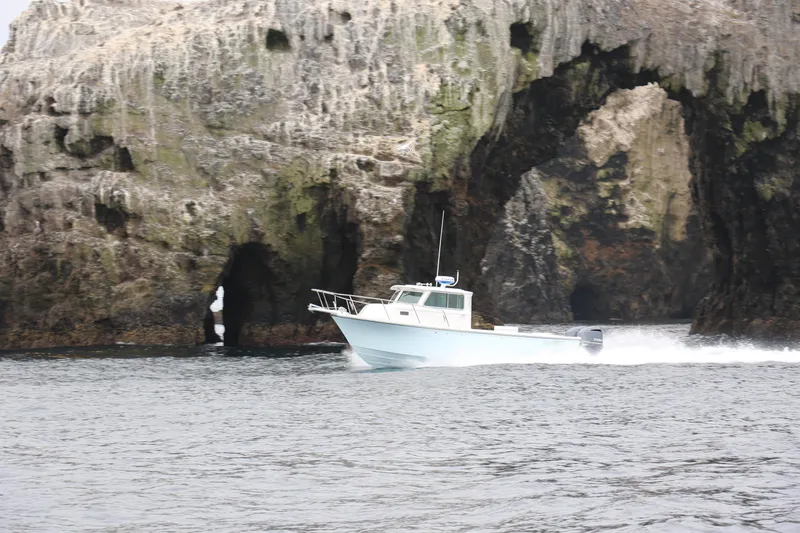 The Image of 2024 Parker 2820XLD boat cruising near rocky cliffs. - 1