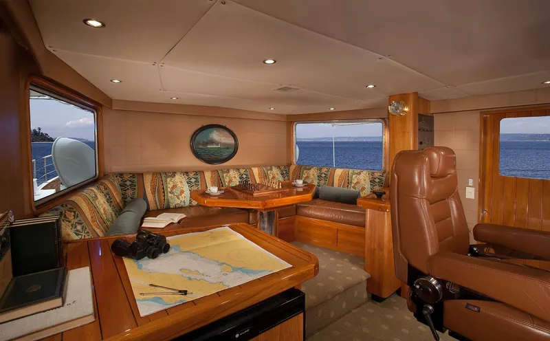 Slide: The Image of Luxurious interior of 1967 Superyacht Punat with ocean view, plush seating, and navigation table. - 4
