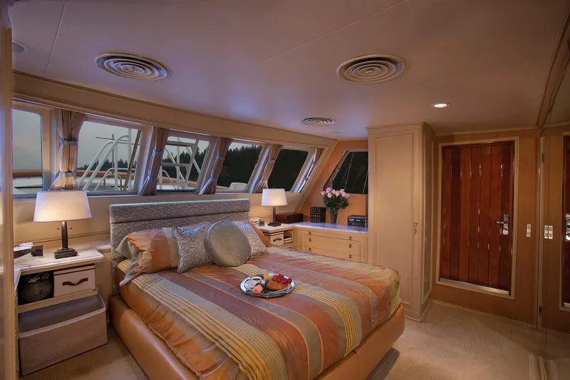 Slide: The Image of Luxurious bedroom on a 1967 Superyacht Punat with panoramic windows and elegant decor. - 5