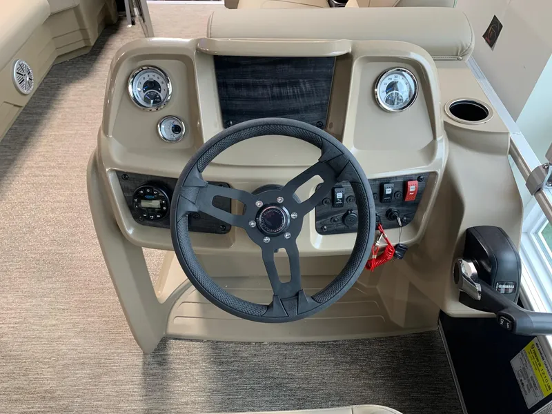 Slide: The Image of 2024 Starcraft LX20 R boat dashboard with steering wheel and control panel. - 4