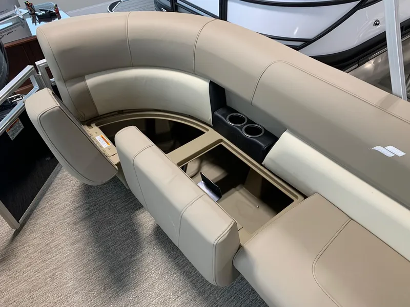 Slide: The Image of 2024 Starcraft LX20 R boat with beige seating and storage compartments. - 6