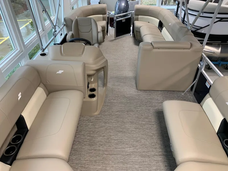 Slide: The Image of 2024 Starcraft LX20 R pontoon boat interior with beige seating and modern design. - 8