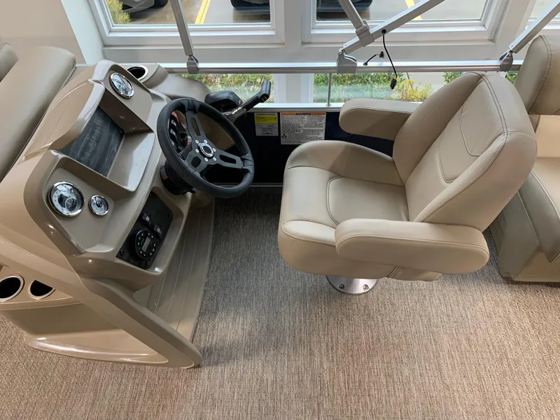 Slide: The Image of 2024 Starcraft LX20 R boat helm with beige captain's chair and control panel. - 3