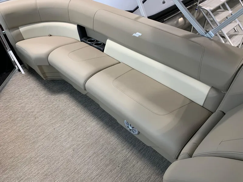 Slide: The Image of 2024 Starcraft LX20 R boat interior with beige seating and cup holders. - 5