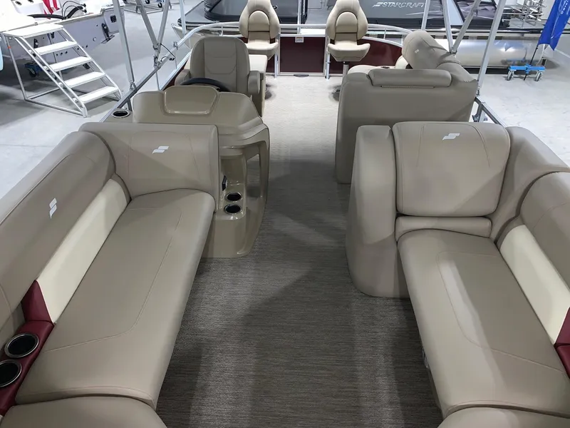 Slide: The Image of 2024 Starcraft LX22 F pontoon boat interior with beige seating and modern design. - 10