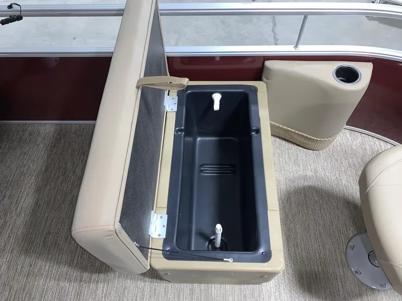 Slide: The Image of 2024 Starcraft LX22 F boat with open storage compartment and cup holder. - 4