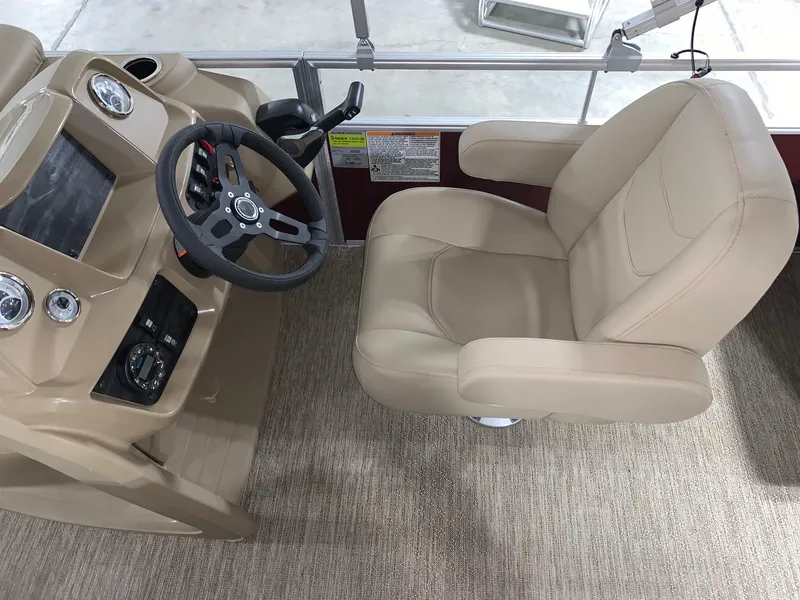 Slide: The Image of 2024 Starcraft LX22 F boat helm with beige captain's chair and steering wheel. - 5