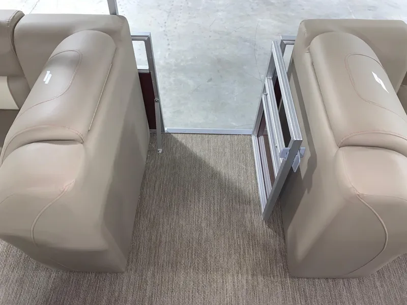 Slide: The Image of 2024 Starcraft LX22 F boat interior with beige seating and open gate. - 7