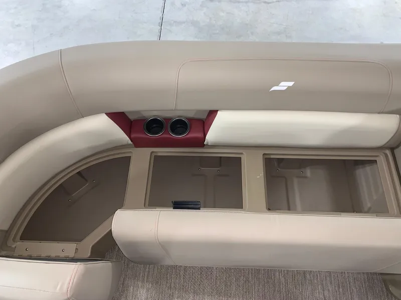 Slide: The Image of 2024 Starcraft LX22 F boat interior seating with storage compartments and cup holders. - 8