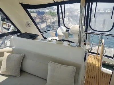 Slide: The Image of Interior view of 2003 Riviera 48 Conv yacht with seating and helm. - 15