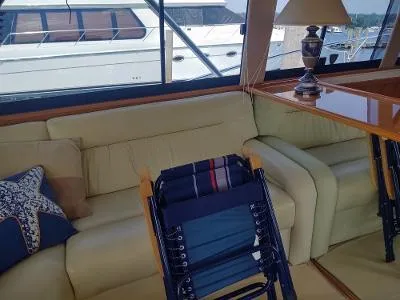 Slide: The Image of Interior of 2003 Riviera 48 Conv yacht with beige sofa and nautical decor. - 20