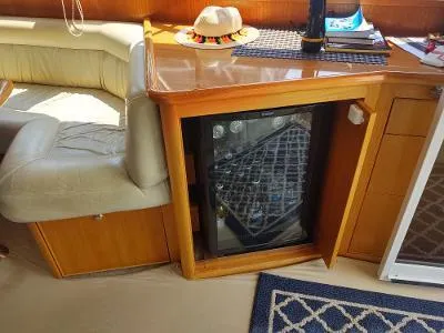 Slide: The Image of Interior of 2003 Riviera 48 conv yacht with mini fridge and seating area. - 22