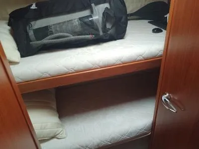 Slide: The Image of Bunk beds in 2003 Riviera 48 Conv yacht cabin with luggage on top bunk. - 26
