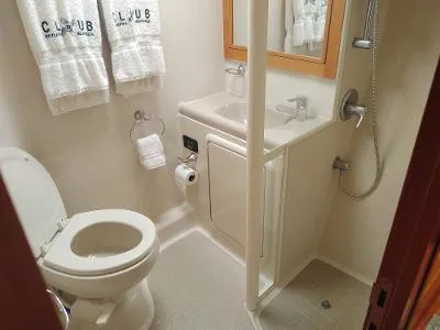 Slide: The Image of Compact bathroom in a 2003 Riviera 48 conv yacht with toilet, sink, and shower. - 28