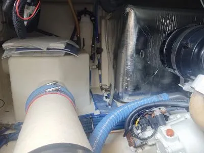 Slide: The Image of Engine room of 2003 Riviera 48 conv yacht, showcasing mechanical components and wiring. - 33