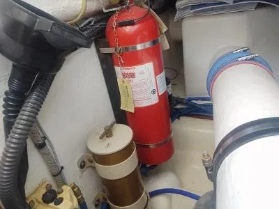 Slide: The Image of Engine room of 2003 Riviera 48 conv with fire extinguisher and mechanical components. - 34