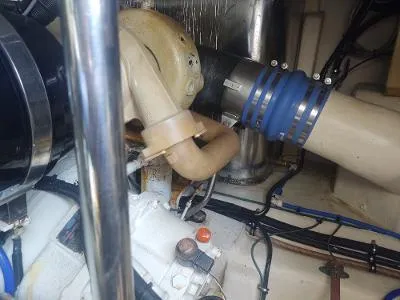 Slide: The Image of Engine compartment of a 2003 Riviera 48 Conv boat, showing pipes and mechanical components. - 36