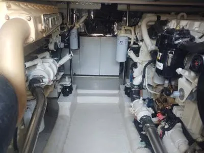 Slide: The Image of Engine room of 2003 Riviera 48 Conv yacht, showcasing mechanical components and piping. - 38