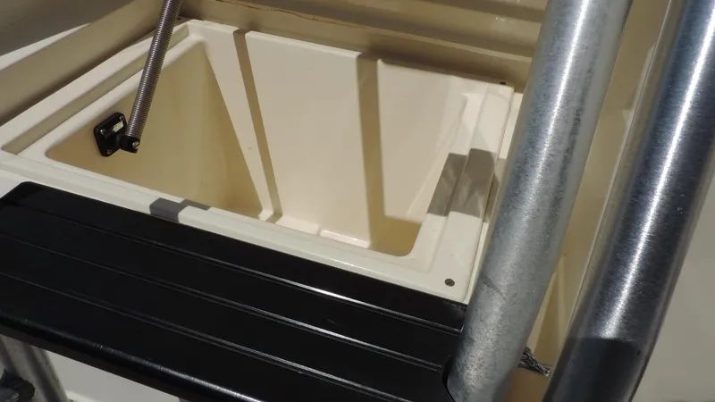 Slide: The Image of Storage compartment on a 2003 Riviera 48 Conv boat, featuring a sturdy latch and metal railing. - 4