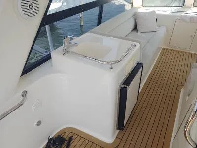 Slide: The Image of Luxurious 2003 Riviera 48 Conv yacht interior with sleek seating and elegant wood flooring. - 40