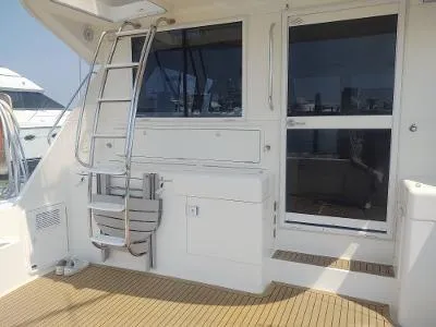 Slide: The Image of 2003 Riviera 48 Conv yacht deck with ladder and sliding door. - 7