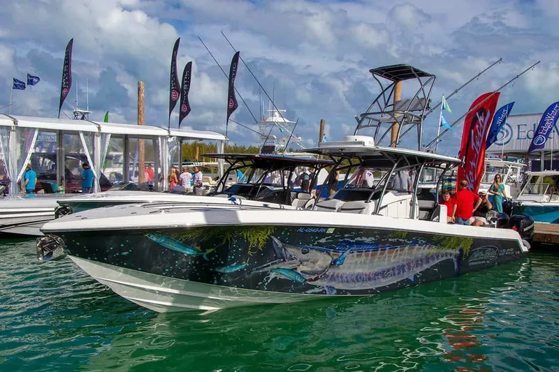 Slide: The Image of 2023 Nor-Tech 392 Super Fish boat at a marina, featuring vibrant fish graphics. - 7