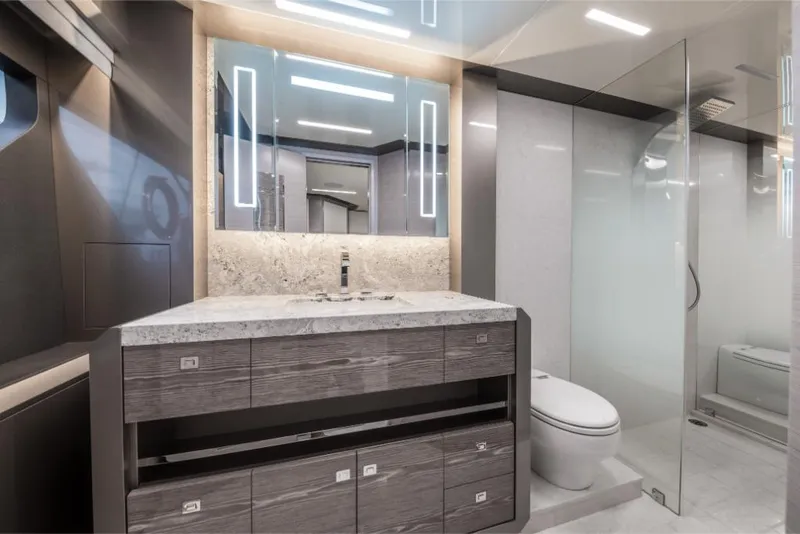 Slide: The Image of Modern bathroom on the 2023 Ocean Alexander 35R yacht with sleek vanity and glass shower. - 36