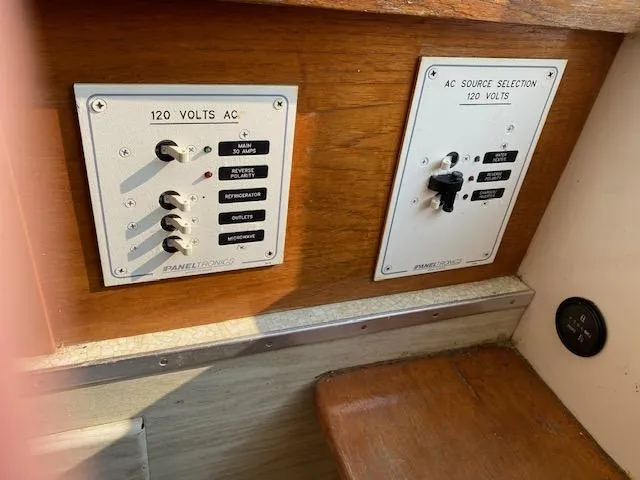 Slide: The Image of 1972 Bertram Express electrical panel with 120 volts AC switches and source selection. - 11