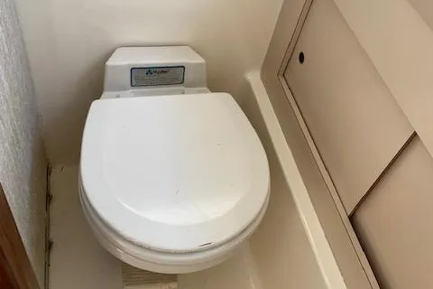 Slide: The Image of 1972 Bertram Express boat toilet, compact marine bathroom setup. - 14