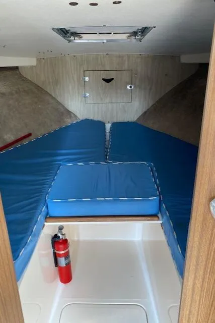 Slide: The Image of 1972 Bertram Express cabin interior with blue cushions and fire extinguisher. - 15