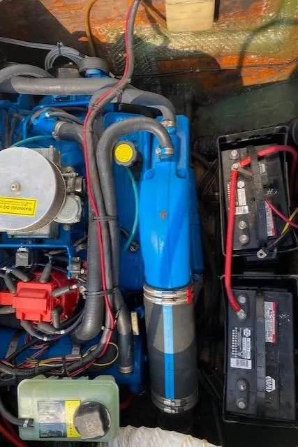 Slide: The Image of Engine compartment of a 1972 Bertram Express boat with visible batteries and wiring. - 17