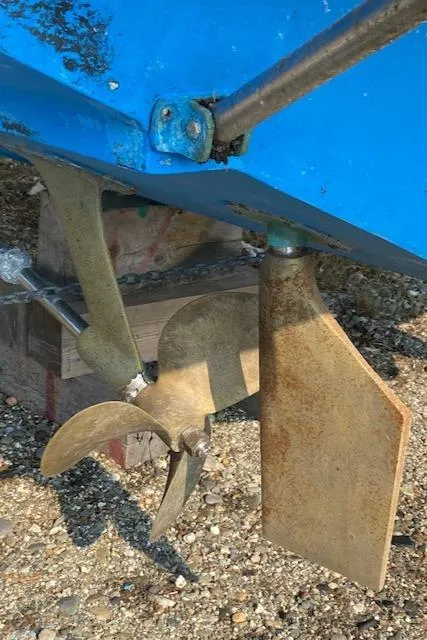 Slide: The Image of 1972 Bertram Express boat propeller and rudder, close-up view. - 19