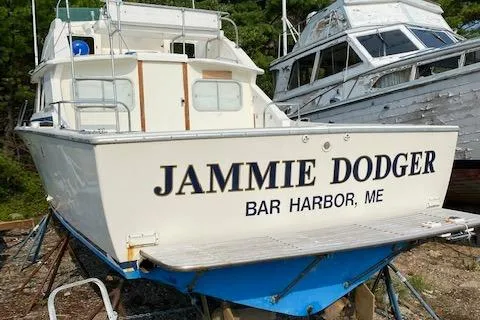 Slide: The Image of 1972 Bertram Express boat named "Jammie Dodger" in Bar Harbor, ME, on land. - 22