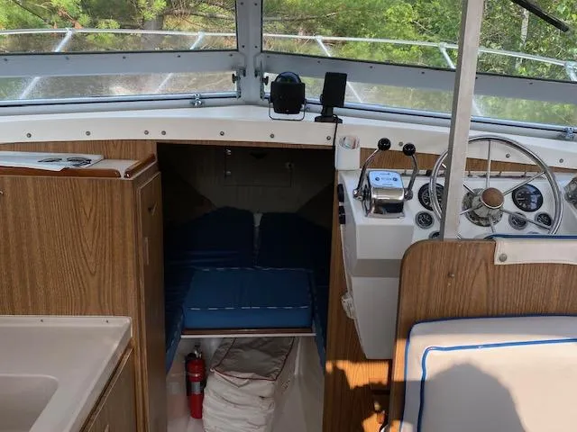 Slide: The Image of 1972 Bertram Express boat interior with steering wheel, control panel, and cabin entrance. - 3