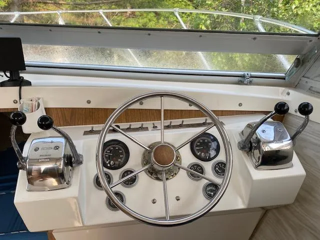 Slide: The Image of 1972 Bertram Express boat helm with steering wheel and control panels. - 4
