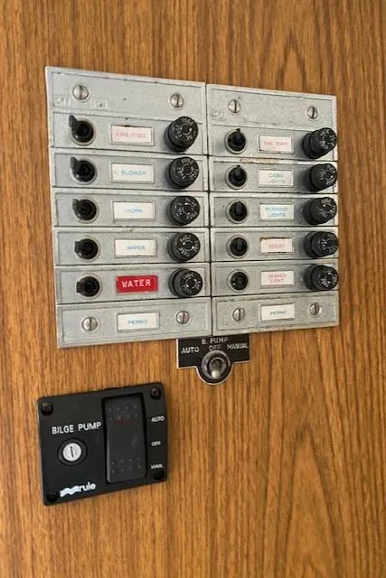 Slide: The Image of 1972 Bertram Express electrical panel with labeled switches and bilge pump control. - 16