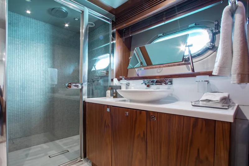 Slide: The Image of Luxurious bathroom in 2014 Sunseeker 131 yacht with modern shower and wooden cabinetry. - 26