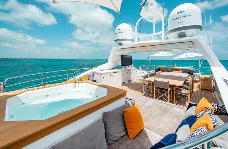 Slide: The Image of Luxurious Sunseeker 131 yacht deck with hot tub, dining area, and ocean view. - 42