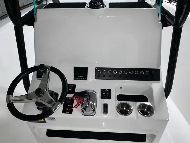 Slide: The Image of 2024 Cape Horn 22 OS boat console with steering wheel and controls. - 11