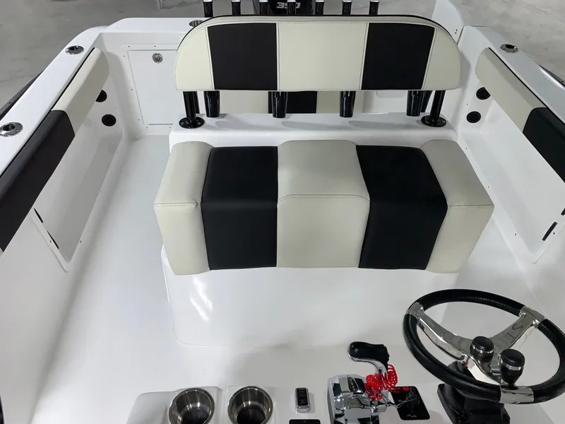Slide: The Image of 2024 Cape Horn 22 OS boat interior with black and white seating and steering console. - 14