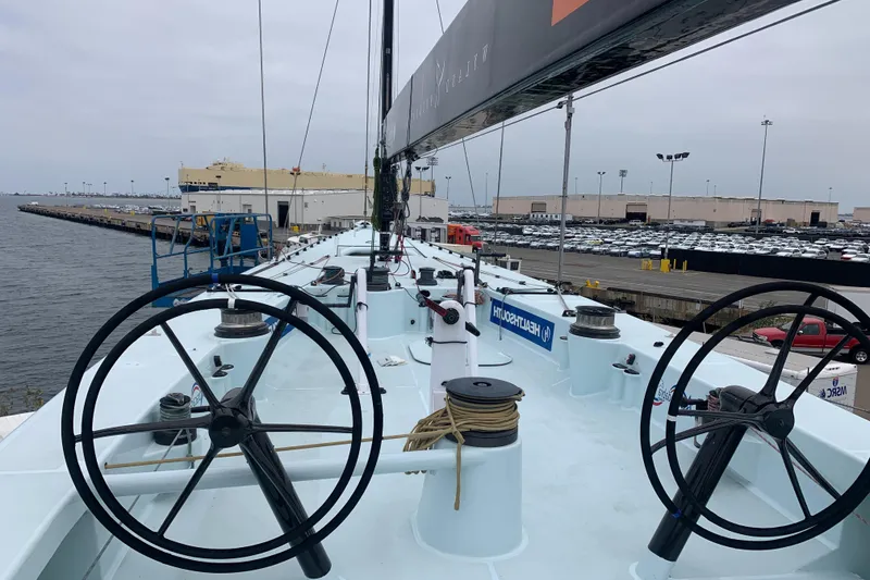 Slide: The Image of Custom Americas Cup Class 75 yacht, 2000, docked with dual steering wheels and sleek deck design. - 11