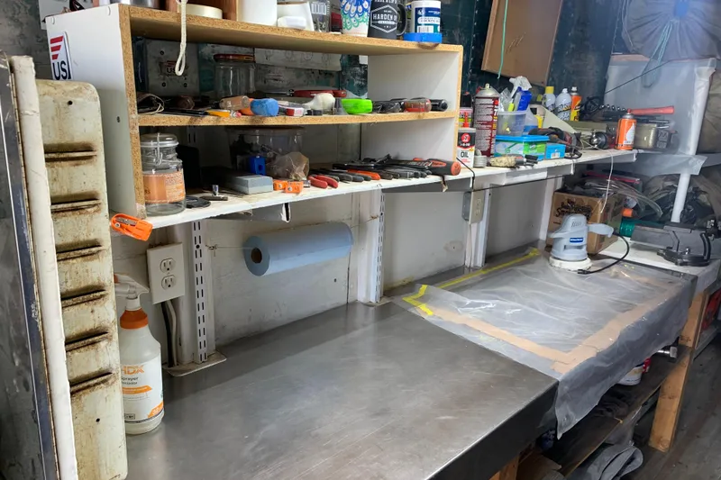 Slide: The Image of Organized workshop with tools, supplies, and a stainless steel workbench. - 18