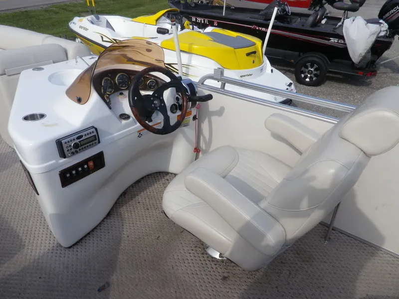 Slide: The Image of Captain's seat and control console of a 2006 South Bay 925 pontoon boat. - 7