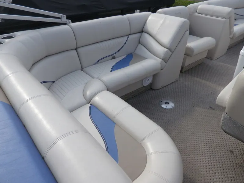 Slide: The Image of Interior seating of a 2006 South Bay 925 pontoon boat with beige and blue upholstery. - 9