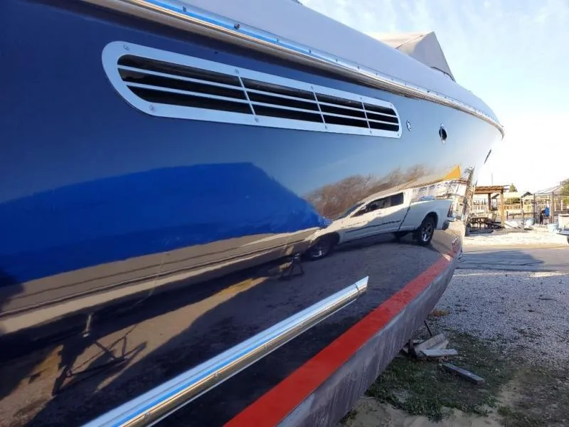 Slide: The Image of 2006 Chris-Craft 36 Corsair Heritage boat with sleek blue hull and red stripe. - 46