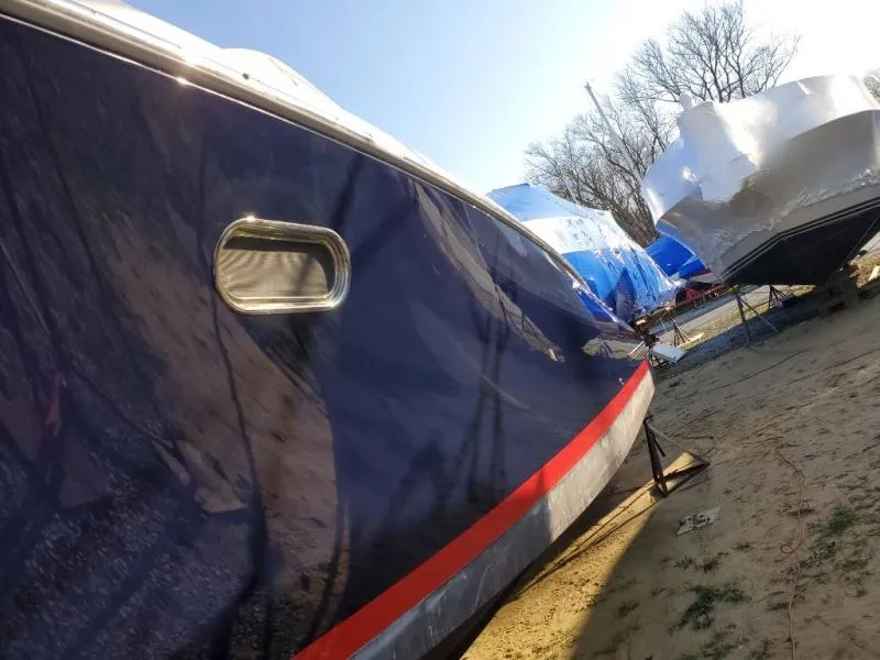 Slide: The Image of 2006 Chris-Craft 36 Corsair Heritage boat in storage, side view with protective covers. - 48