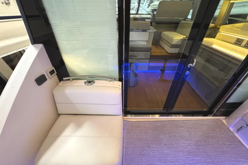 Slide: The Image of 2020 Tiara Yachts C49 Coupe interior with modern seating and ambient lighting. - 13