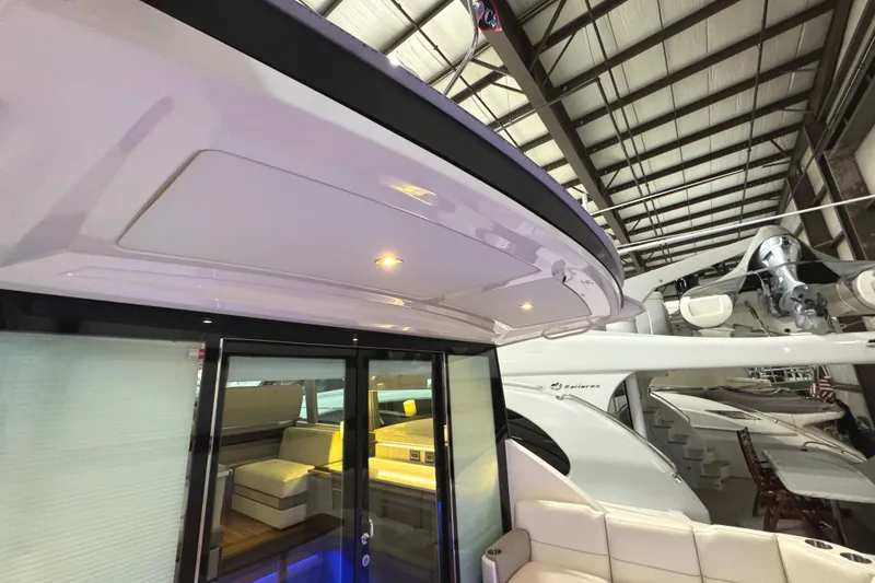 Slide: The Image of 2020 Tiara Yachts C49 Coupe interior view with modern seating and lighting. - 14