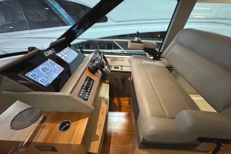 Slide: The Image of 2020 Tiara Yachts C49 Coupe helm with modern controls and leather seating. - 16
