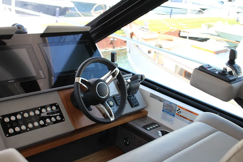 Slide: The Image of Interior helm of 2020 Tiara Yachts C49 Coupe with modern controls and displays. - 17